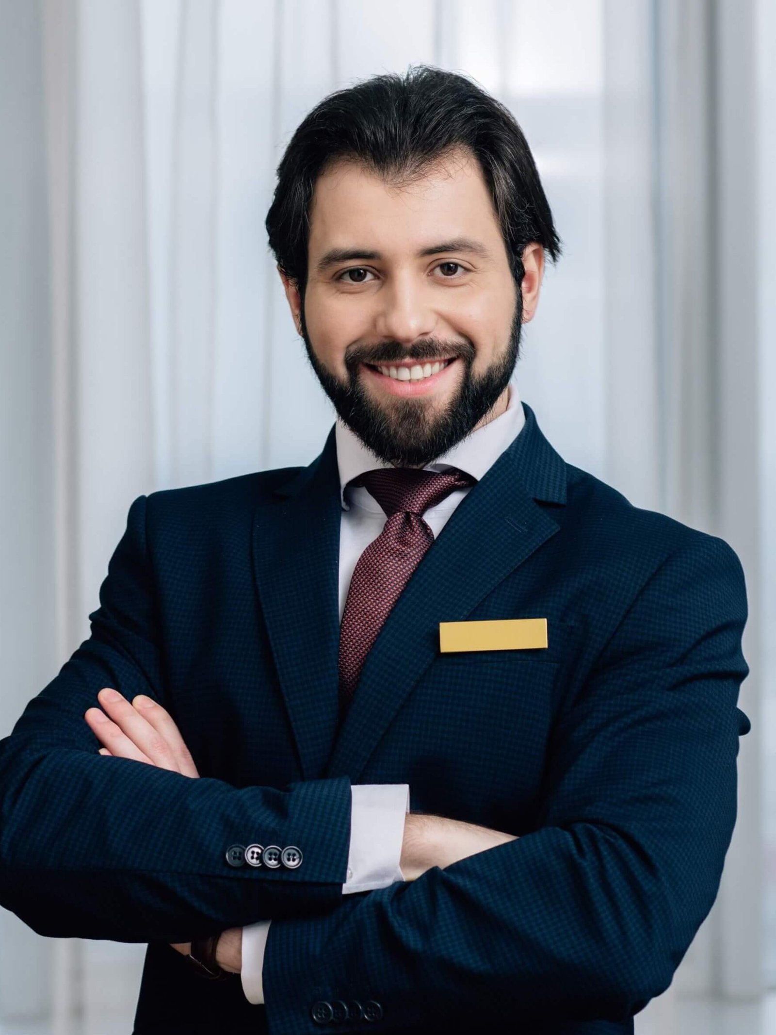 handsome-hotel-administrator-with-crossed-arms-loo-2024-11-17-13-39-25-utc-1.jpg
